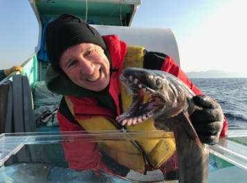 Photo of Dr. David A. Ebert holding a small shark